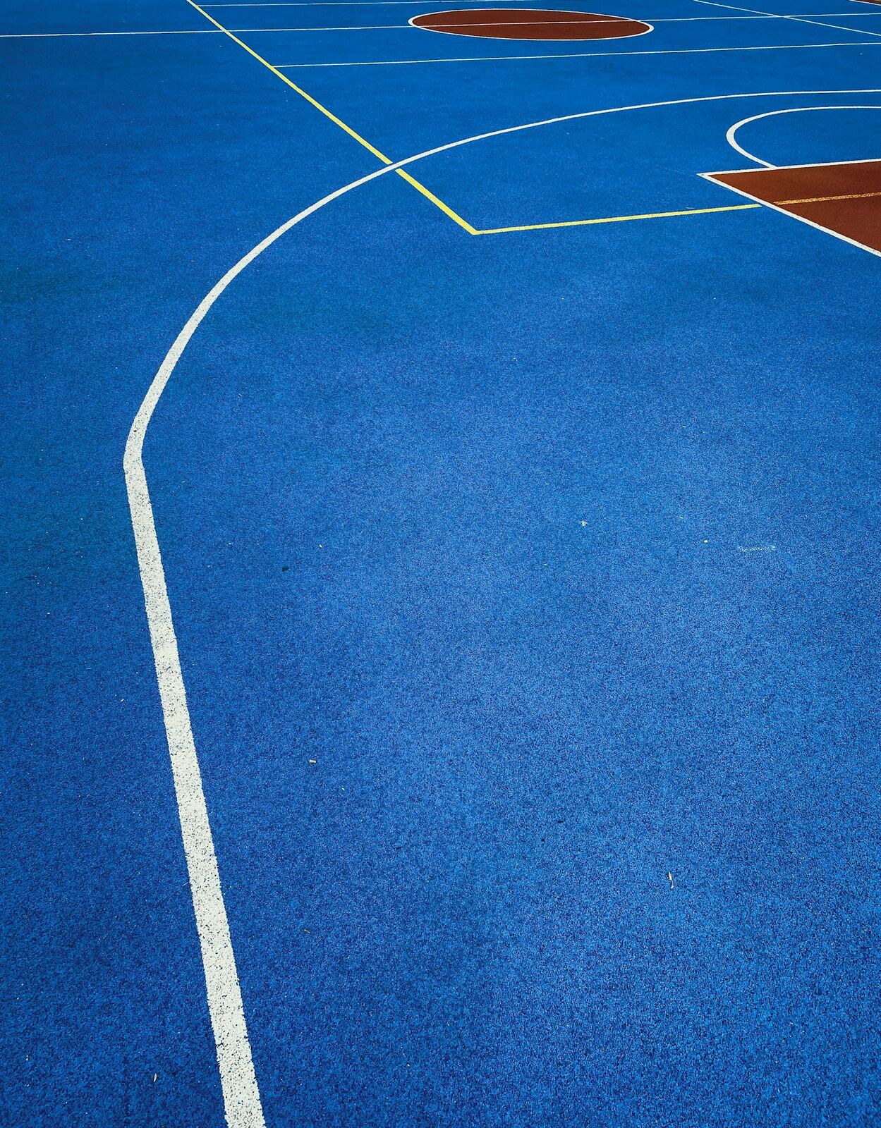 Basketball court line markings in blue and white